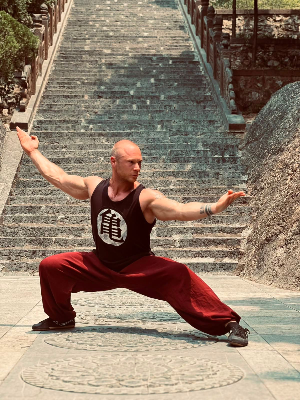 Julian Jacobi in a deep stance in front of temple stairs