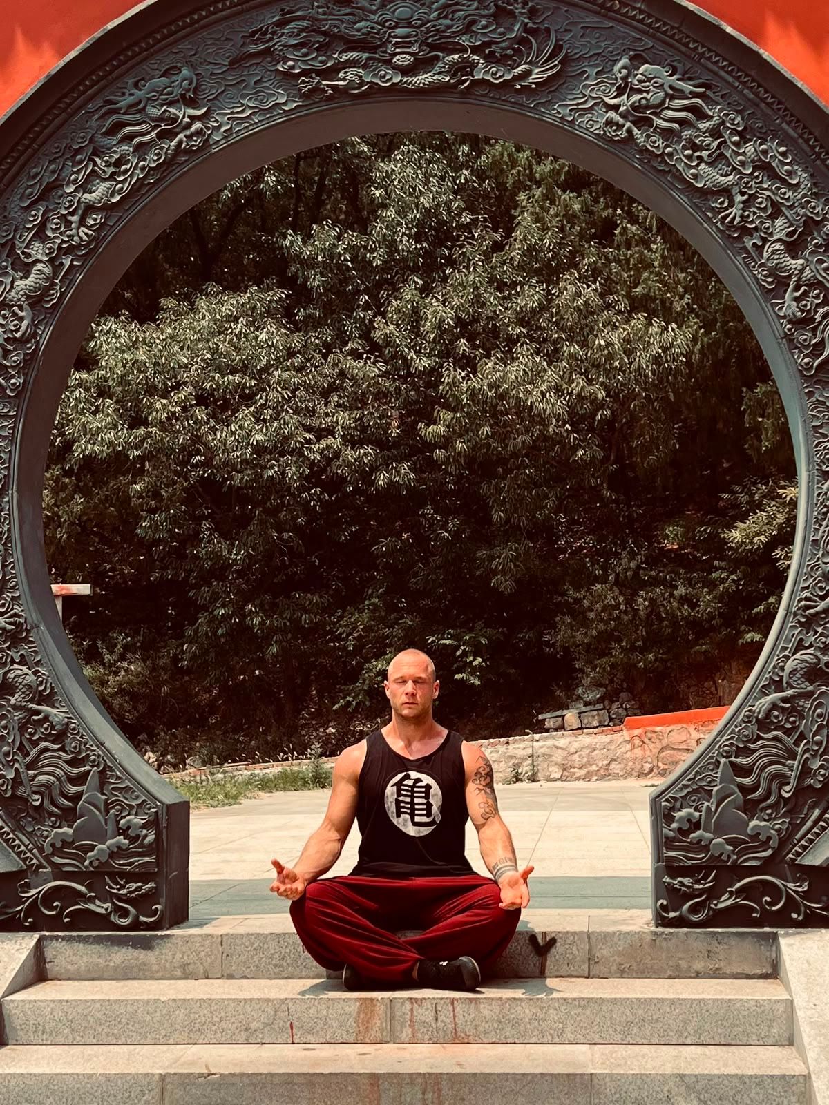 Julian Jacobi meditating in a Chinese moon gate